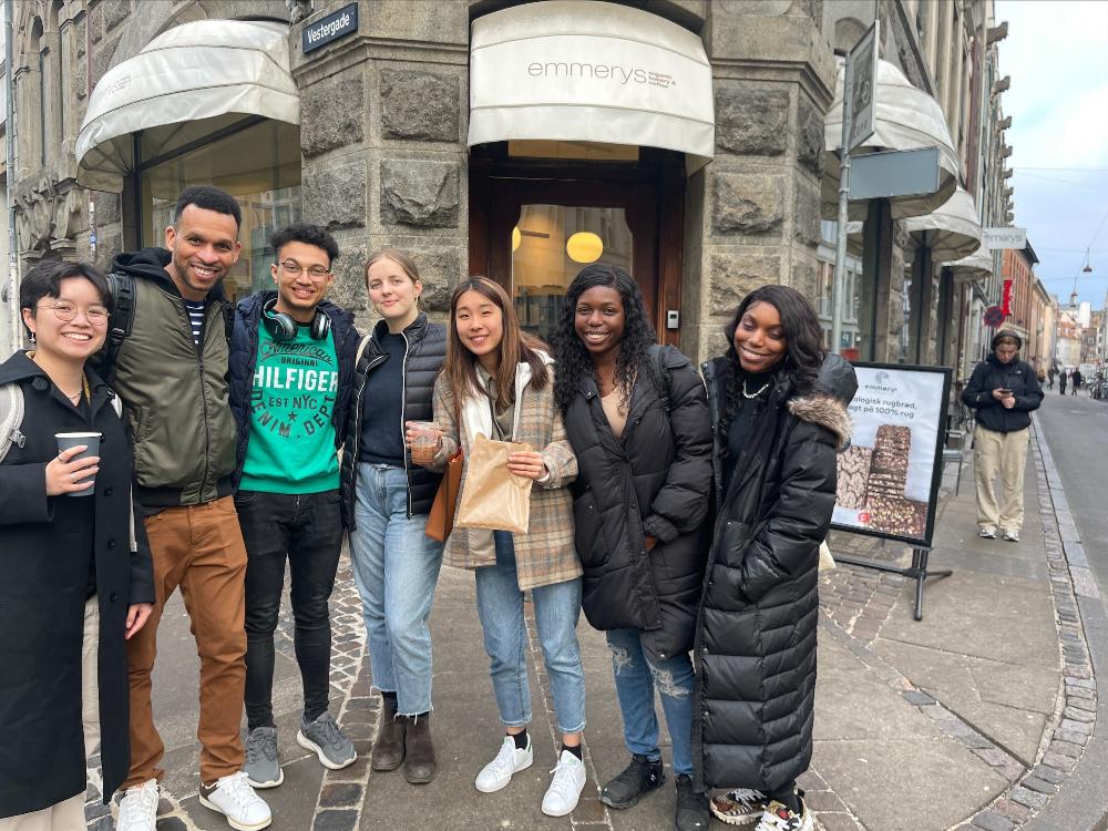 Group of six students and an Education Abroad advisor standing on a street in Copenhagen