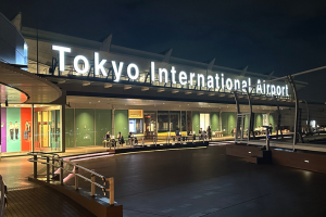 Exterior of building with large white sign reading Tokyo International Airport
